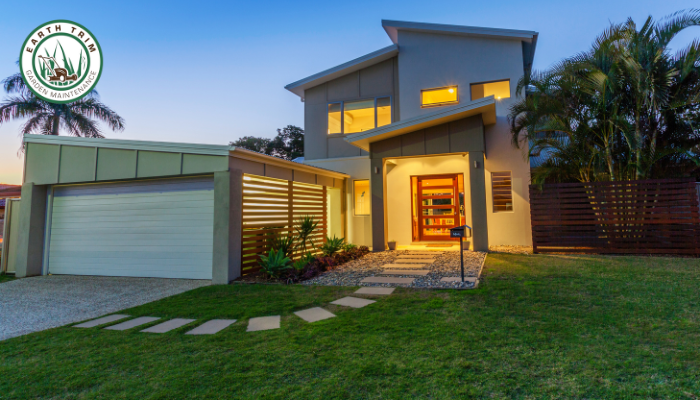 Professional gardener Ryan Gawly performing expert winter pruning on a dormant deciduous tree in a Chelsea garden. He is safely using loppers to shape the tree's structure and encourage healthy spring growth.
